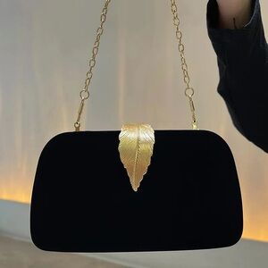 Elegant Black Clutch with Gold Leaf Accent